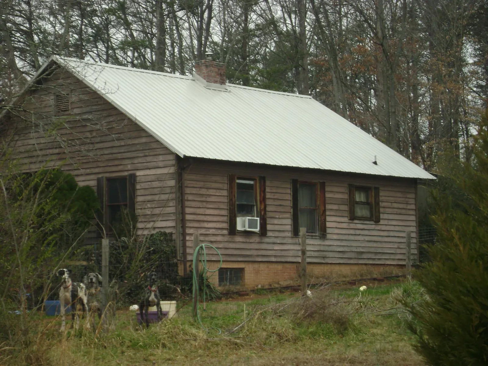 White metal roof on an old wood sided farmhouse, from a Metal Roof Installation job in Ophiem